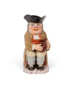 A Neale & Co creamware Toby jug, c.1795, seated with an empty jug of ale, his long-stemmed clay 
