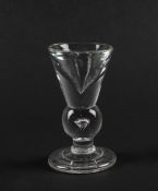A rare deceptive baluster dram glass, c.1740-50, the thick funnel bowl raised on a bulbous knopped s