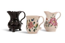 A salt-glazed stoneware milk jug and a 'capuchin' cup, mid 18th century, the jug painted with a larg