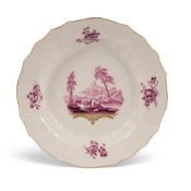 A Tournai plate attributed to Michel-Joseph Duvivier, c.1763-71, painted in puce monochrome with fig