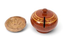A Sussex pottery slipware money box, dated 1839, the squat globular form decorated in a rich treacle