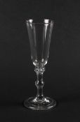 A balustroid ale glass, c.1735-45, the slender round funnel bowl raised on a plain balustroid stem w