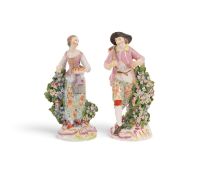 A pair of Derby figures of harvesters, c.1760, she carrying a sheaf of corn and a flask of wine, he 