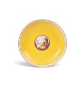 A Mansfield-decorated Coalport saucer dish, c.1800, the well painted in sepia monochrome with a ruin