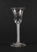 An unusual engraved wine glass, c.1760, the bell bowl engraved with a single bird perched on a leafy