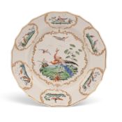 A Tournai plate, c.1770, painted in the Chelsea manner with a pair of peacocks perched below other e
