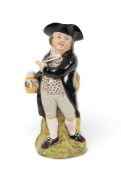 An unusual Hearty Good Fellow Toby jug, c.1820-30, standing in dynamic pose holding a clay pipe and 