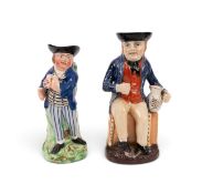 Two Toby jugs of sailors, c.1810-30, one a Hearty Good Fellow, wearing a blue jacket over striped tr