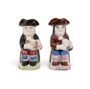 Two Portobello Toby jugs, c.1820-40, with bold floral decoration to their jugs of ale, one with a bl