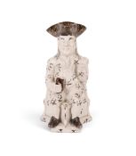 A pearlware Squire Toby jug, c.1790, crisply modelled seated on a corner chair, his outfit sponged i