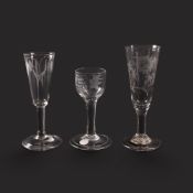 Two ale glasses and a wine glass, mid 18th century, the ales with slender funnel bowls, one unusuall