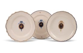 Two Tournai plates and a saucer dish, c.1790-1800, each well bearing an oval blue roundel with gilt 