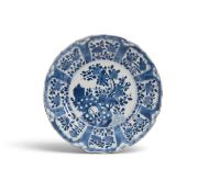 A Chinese porcelain blue and white plate or dish, Kangxi 1662-1722, the well painted with flowering 