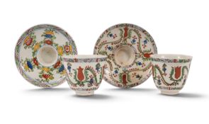 Two Kutahya (Turkey) pottery cups or beakers and saucers, 1st half 18th century, decorated with styl