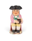A Staffordshire pearlware Toby jug, c.1800-10, of Ordinary type, seated with a large foaming jug and