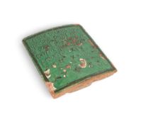 A green-glazed faïence stove tile, dated 1733, France or Switzerland, inscribed 'en tout travail il 