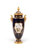 A tall Coalport vase and cover by Percy Simpson, early 20th century, painted with an exotic bird in 