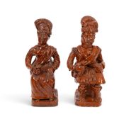 A rare pair of Pill Pottery (Welsh) figures of a Scotsman and his companion, mid 19th century, each 