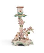 A Derby candlestick group, c.1760-65, modelled with two dogs at the base of a tree applied with larg