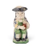 A pearlware Toby jug of Ordinary type, c.1790-1800, with exuberant foam on his jug of ale, wearing a