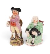 Two Toby jugs, c.1810-30, one a Hearty Good Fellow, holding a patterned jug of ale and a long-stemme