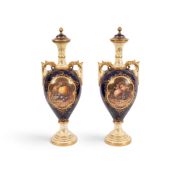 A pair of Coalport vases and covers by Frederick Chivers, c.1920, the slender forms painted with pan