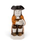 A rare double-based Toby jug, c.1790-1800, seated with a foaming jug of ale, his coat decorated a ri