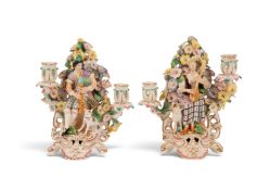 A pair of Derby candlestick figures of Scottish musicians, c.1800, he wearing tartan breeches and pl