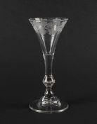 A balustroid wine glass of Kit Kat type, c.1740, the drawn trumpet bowl engraved with a continuous b