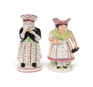 Two female Toby jugs, c.1820-30, one a Gin Woman, standing and holding a bottle and glass, raised on