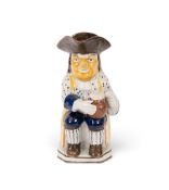 A Pratt ware 'Convict' Toby jug, c.1790-1800, his coat patterned with arrows, wearing striped stocki