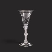 A wine glass of possible Jacobite significance, c.1760, the bell bowl finely engraved with a carnati