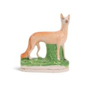 A rare Staffordshire figure of a fox, 1st half 19th century, standing with head turned to dexter, ra