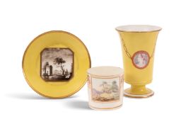 A Pinxton coffee can, c.1800, painted with a rectangular landscape panel within a wide band of puce 