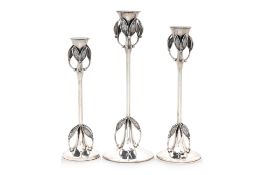 A SET OF THREE GRADUATED STERLING SILVER CANDLESTICKS