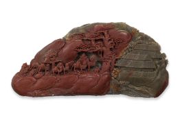 A CARVED GREEN AND RED SOAPSTONE BOULDER