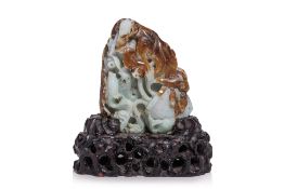 A CARVED GREEN AND RUSSET JADEITE BOULDER