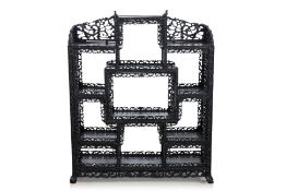 A CARVED BLACKWOOD DISPLAY SHELF