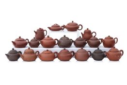 A GROUP OF 18 SMALL YIXING POTTERY TEAPOTS