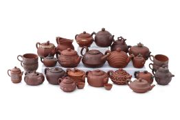 A GROUP OF 26 YIXING TEAPOTS AND TEA WARES