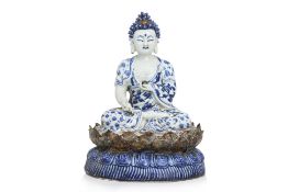 A BLUE AND WHITE MODEL OF BUDDHA SEATED ON A LOTUS BASE