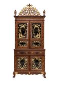 A LARGE CARVED AND PARCEL-GILT TEAK CABINET