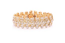 A GOLD AND DIAMOND STRAP BRACELET
