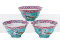 A SET OF THREE FAMILLE ROSE TURQUOISE GROUND 'PHOENIX AND PEONY' TEA BOWLS