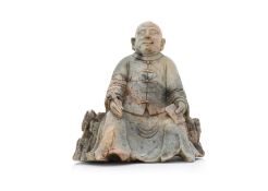 A CELADON AND RUSSET SOAPSTONE FIGURE OF A SEATED SCHOLAR