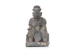 A CARVED GREY STONE FIGURE OF GUANDI