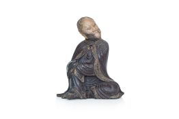 A CARVED SOAPSTONE FIGURE OF A LUOHAN