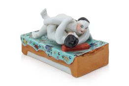 A CHINESE PORCELAIN EROTIC FIGURAL GROUP