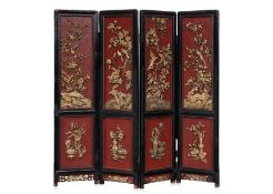 A FOUR PANEL GILT AND LACQUER SCREEN