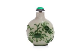 A GREEN OVERALY GLASS SNUFF BOTTLE DECORATED WITH CRABS AND SHRIMP